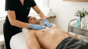 Male chest receiving post-wax skincare treatment with soothing lotion applied to smooth skin after body waxing.