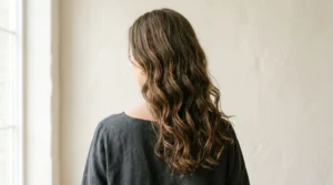 Woman with natural Type 2 wavy hair and soft S-shaped waves.