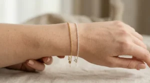 Gold and silver jewelry compared on the wrist to help identify skin undertone.