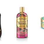 Top tanning bed lotions, including Australian Gold Dark Tanning Accelerator, Ed Hardy Coconut Kisses, and Devoted Creations #TANLIFE, displayed in professional studio product photography.