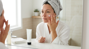 Woman applying gentle moisturizer during chemical peel recovery.