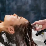 Woman having her hair washed at a salon before a conditioning treatment