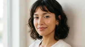 Woman wearing dewy makeup with a fresh luminous complexion and subtle rosy tones