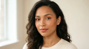 Woman wearing monochromatic makeup in coordinated peach and terracotta tones