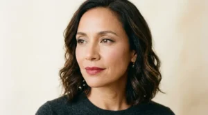 Woman wearing classic makeup with defined eyes, soft blush, and muted red lipstick