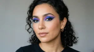 Woman wearing colorful creative makeup with blue and violet eyeshadow