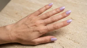 Classic glossy lilac manicure on neatly shaped nails