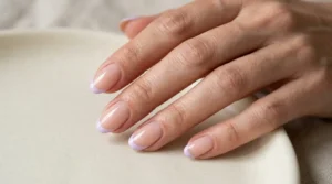 Lilac French tip manicure with a sheer nude base