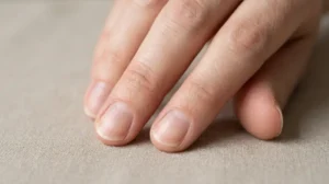 Close-up of fingernails with a subtle spoon-shaped curve