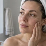 Woman touching tight-feeling skin after washing her face