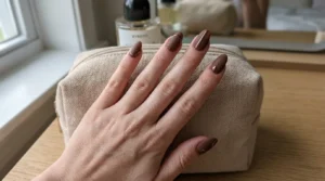 Close-up of matte brown nails with subtle chrome accents