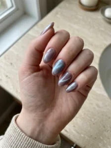 Mauve cat-eye nails with a separate smoky base color and blue-silver magnetic shimmer