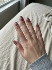 Dusty rose cat-eye nails looking softer and duller under flat indoor lighting