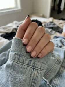 Black cherry French tip nails with a sheer nude base