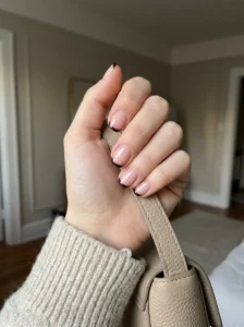 Black cherry micro French tip nails on a natural-looking hand