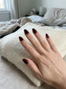 Translucent glossy black cherry jelly nails on a natural-looking hand