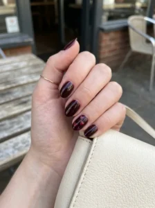 Black cherry nails with delicate heart nail art