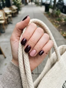 Black cherry nails with a soft pink accent nail