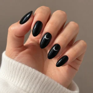 Glossy black almond nails with silver crescent moons on two accent nails.