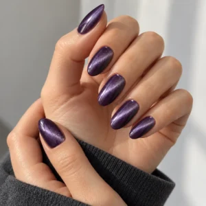 Glossy violet almond nails with diagonal lavender-silver cat eye shimmer.
