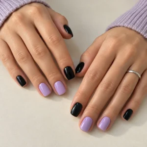 Glossy black nails with soft lilac accents on the middle and ring fingers