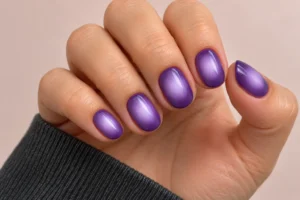 Close-up of purple aura nails with soft lilac centers fading into deep violet edges
