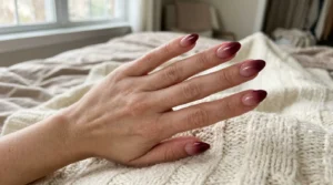 Glossy burgundy ombré nails fading from nude to deep wine